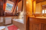 Charming bathroom with wooden finishes and a skylight offering stunning mountain views.