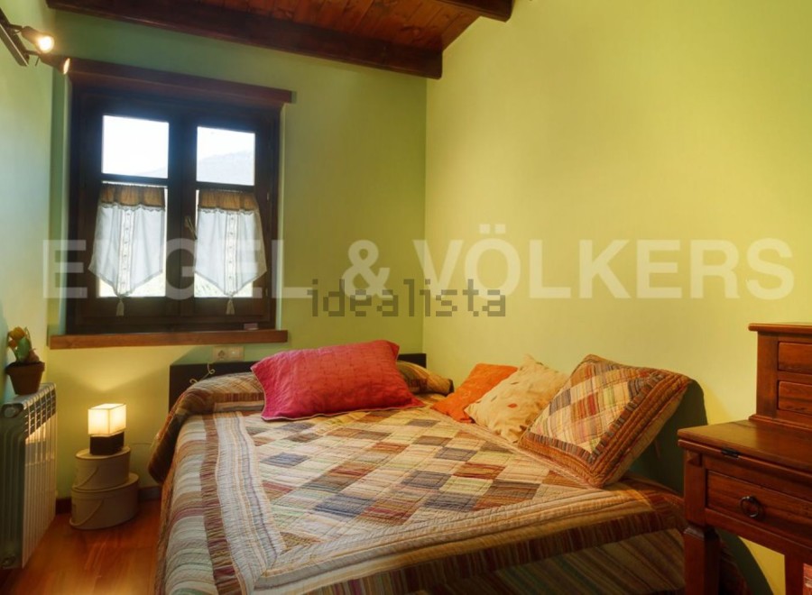 Cozy bedroom with a patchwork quilt, offering a tranquil atmosphere.