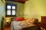 Cozy bedroom with a patchwork quilt, offering a tranquil atmosphere.
