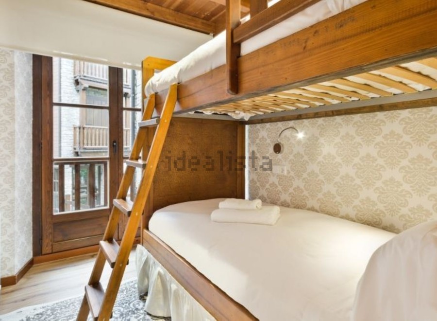 Cozy bunk beds in a charming room with a view.