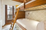 Cozy bunk beds in a charming room with a view.