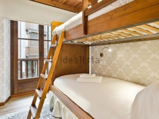 Cozy bunk beds in a charming room with a view.