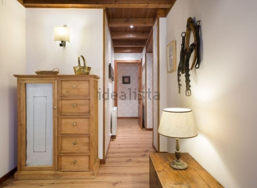 Charming hallway with rustic wooden furniture and unique wall decor.