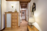 Charming hallway with rustic wooden furniture and unique wall decor.