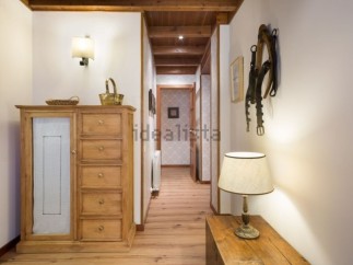 Charming hallway with rustic wooden furniture and unique wall decor.