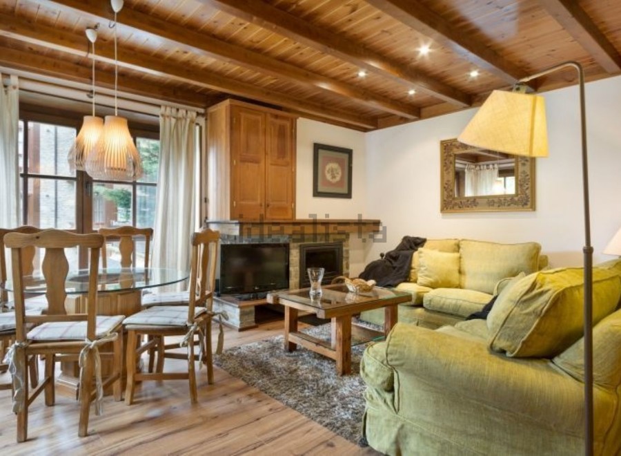 This charming apartment boasts a cozy living room with a fireplace, perfect for relaxing after a day on the slopes.