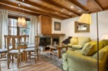 This charming apartment boasts a cozy living room with a fireplace, perfect for relaxing after a day on the slopes.
