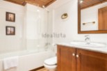 This charming bathroom boasts a clean, modern design with a bathtub and shower combination, perfect for relaxation.