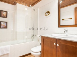This charming bathroom boasts a clean, modern design with a bathtub and shower combination, perfect for relaxation.