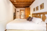 Cozy bedroom with wooden accents and a comfortable bed.