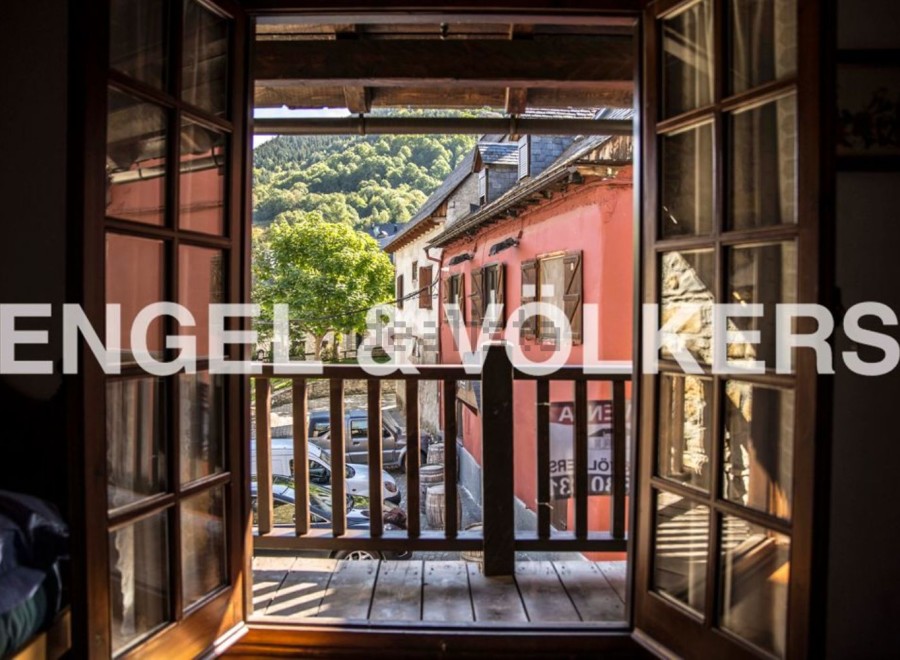 Charming balcony view overlooking a picturesque village setting.