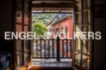 Charming balcony view overlooking a picturesque village setting.