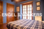 Charming rustic bedroom with wooden floors and double doors.