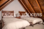 Charming attic bedroom with twin beds and wooden beams.