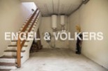This spacious basement offers ample storage solutions, including a dedicated area for firewood and additional space for various items.