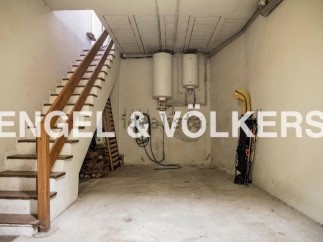 This spacious basement offers ample storage solutions, including a dedicated area for firewood and additional space for various items.