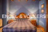 Charming rustic bedroom with wooden headboard and plaid bedding.