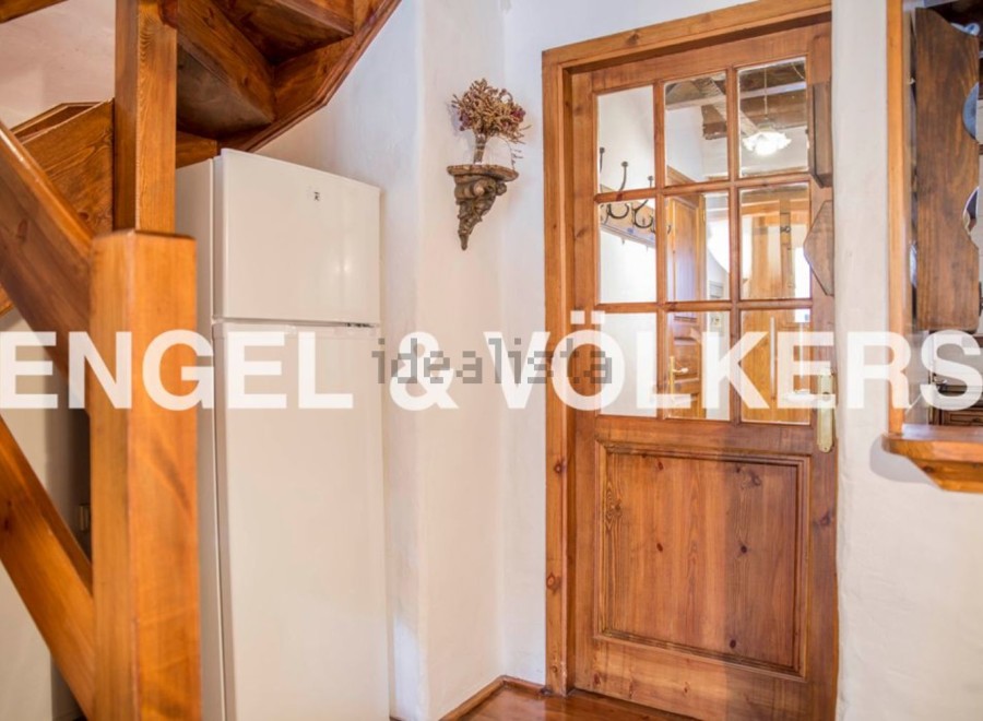 Charming wooden staircase and door add character to this cozy home.