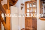 Charming wooden staircase and door add character to this cozy home.