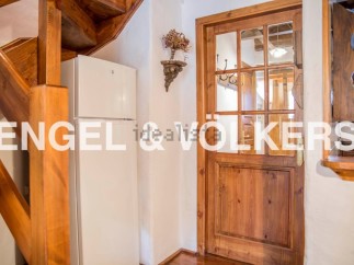 Charming wooden staircase and door add character to this cozy home.