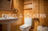 Charming bathroom with wooden walls and rustic details.