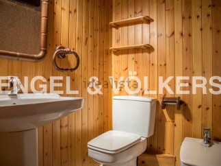 Charming bathroom with wooden walls and rustic details.