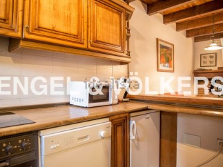 Rustic kitchen with wooden cabinets and modern appliances.