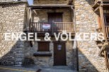 Charming stone house for sale in Andorra, boasting a quaint balcony and traditional wooden features.