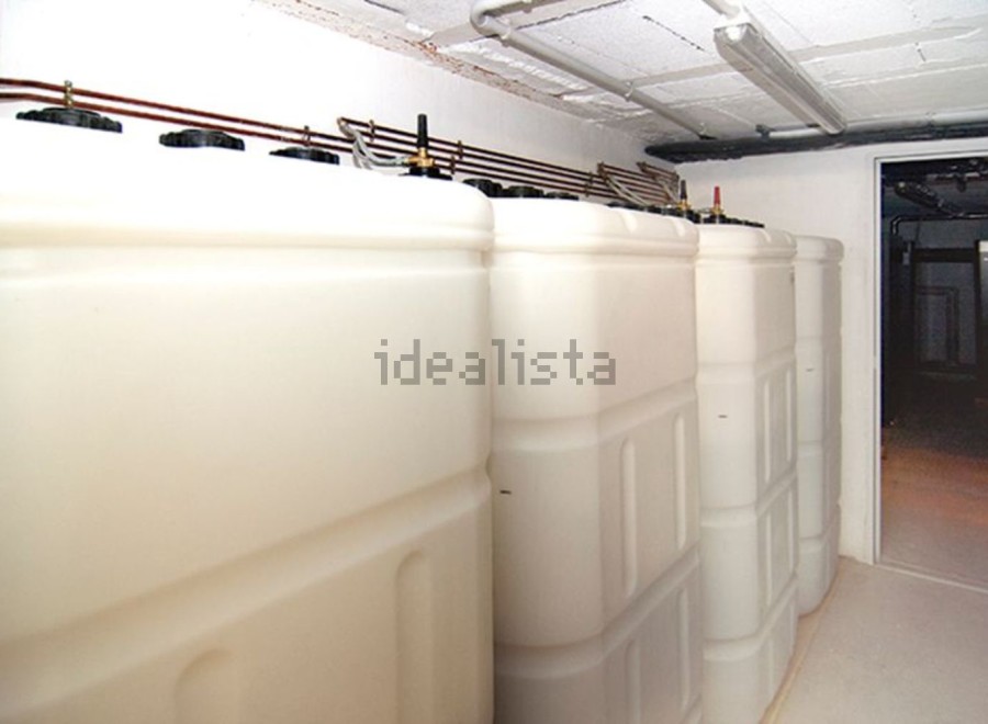 This property features a spacious basement with multiple large storage tanks, ideal for various uses.