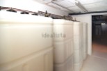 This property features a spacious basement with multiple large storage tanks, ideal for various uses.