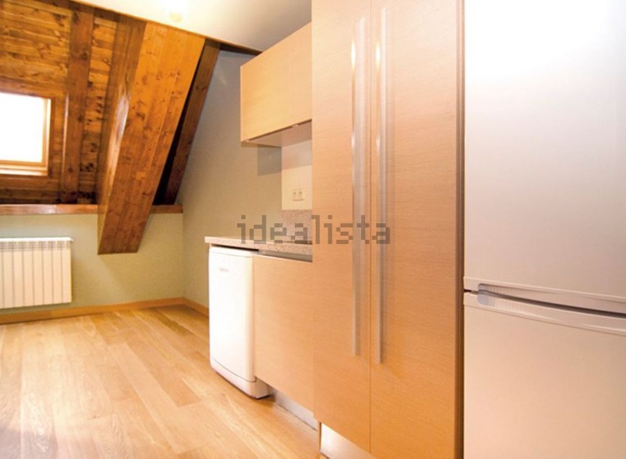 Charming attic apartment with wooden beams and a bright, spacious kitchen.