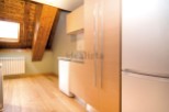 Charming attic apartment with wooden beams and a bright, spacious kitchen.