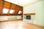 This stunning attic conversion boasts a spacious open-plan layout with gleaming hardwood floors and a cozy fireplace.