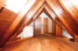 Stunning attic conversion boasts exposed wooden beams and rich hardwood floors.