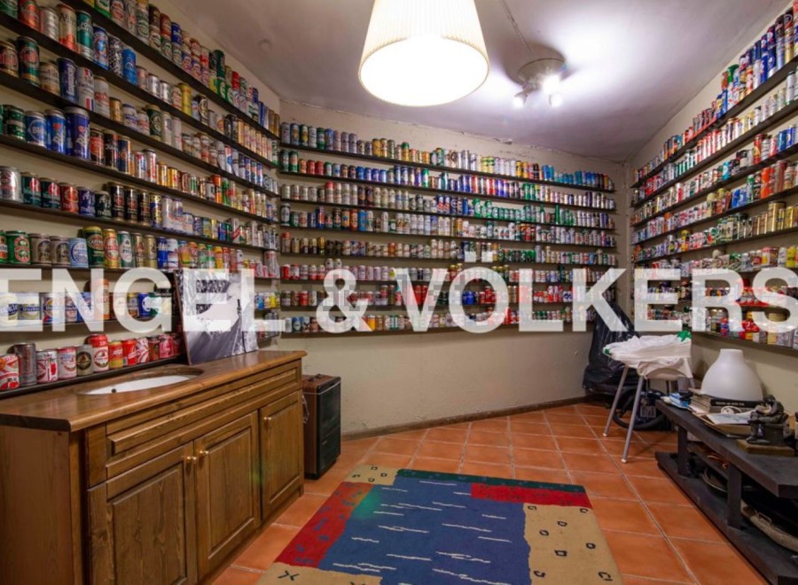Unique property featuring a stunning collection of beer cans displayed on shelves covering the walls.