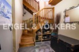 This charming property features a unique wooden staircase as a striking centerpiece.