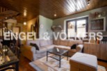 Cozy living room with wooden beams and a large sectional sofa.