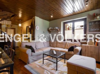 Cozy living room with wooden beams and a large sectional sofa.