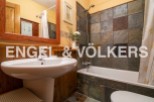 Charming bathroom with rustic wooden accents and slate tile shower.