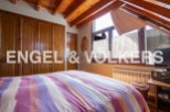 Charming attic bedroom with wooden beams and built-in wardrobe.