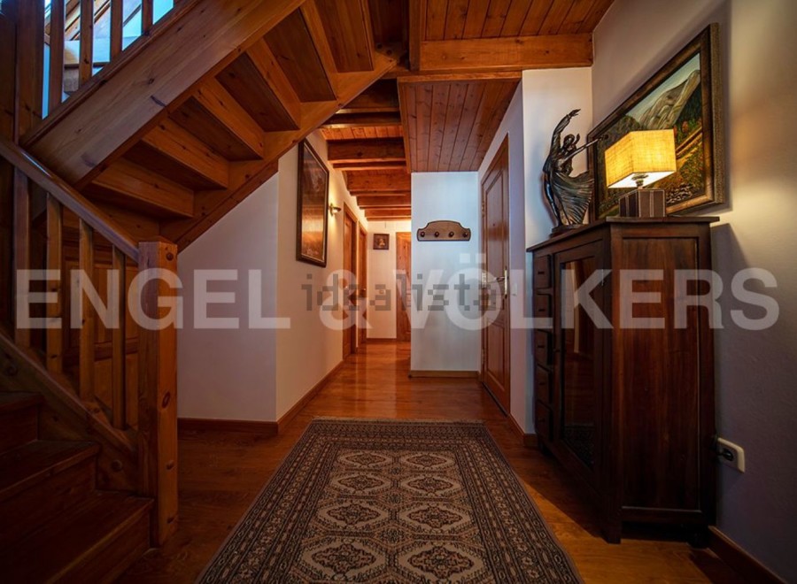 This stunning chalet boasts a grand wooden staircase, adding to its rustic charm.