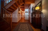 This stunning chalet boasts a grand wooden staircase, adding to its rustic charm.