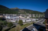 This stunning property boasts breathtaking mountain views and is conveniently located near a large parking area.