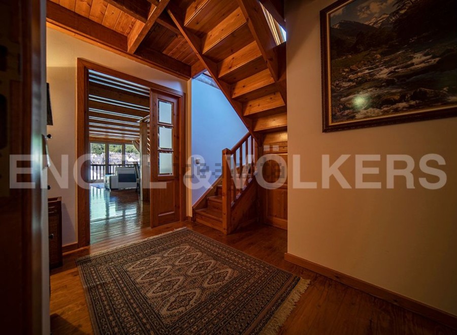 This stunning property boasts a grand wooden staircase, adding a touch of elegance to the hallway.