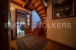 This stunning property boasts a grand wooden staircase, adding a touch of elegance to the hallway.
