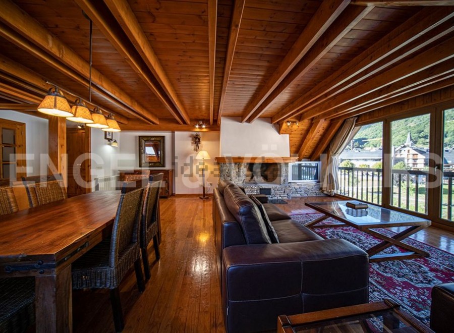This stunning chalet boasts a spacious open-plan living area with a cozy fireplace, perfect for relaxing after a day on the slopes.