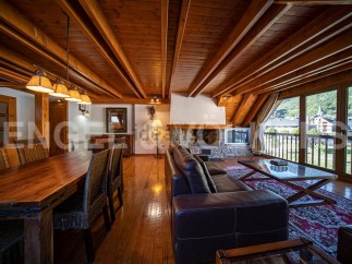 This stunning chalet boasts a spacious open-plan living area with a cozy fireplace, perfect for relaxing after a day on the slopes.