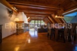 This stunning attic apartment boasts a spacious open-plan living area with hardwood floors, a cozy fireplace, and large windows offering breathtaking views.