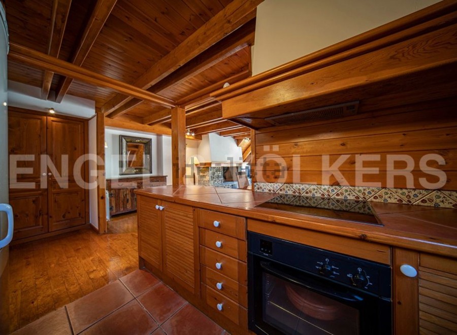 This charming property boasts a rustic-chic kitchen with wooden cabinetry and tiled backsplash.
