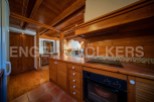This charming property boasts a rustic-chic kitchen with wooden cabinetry and tiled backsplash.